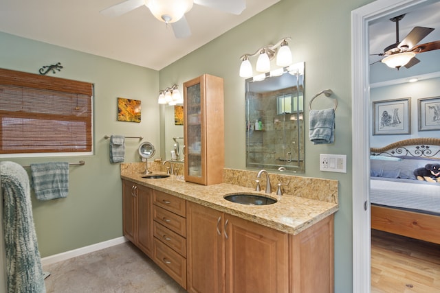 bathroom with ceiling fan, vanity, and a shower with shower door