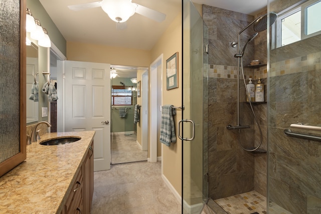 bathroom featuring vanity, an enclosed shower, and a wealth of natural light