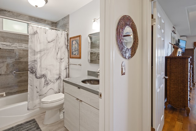 full bathroom featuring shower / bath combo with shower curtain, vanity, wood-type flooring, and toilet