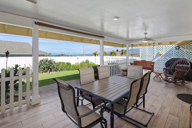 sunroom / solarium featuring ceiling fan