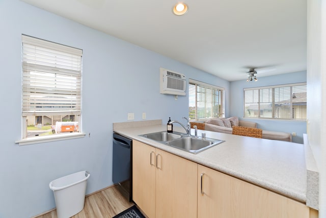 kitchen with dishwasher, kitchen peninsula, sink, light wood-type flooring, and light brown cabinetry