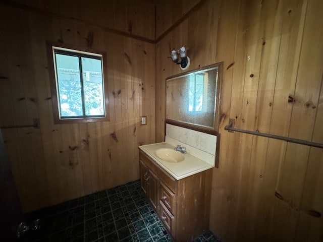 bathroom featuring vanity and wood walls