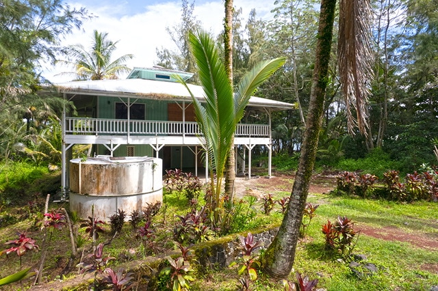 back of property with a jacuzzi