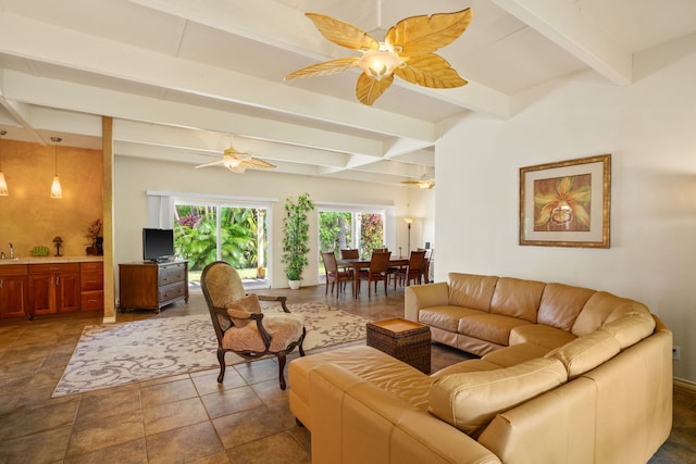 tiled living room featuring sink, ceiling fan, and beam ceiling