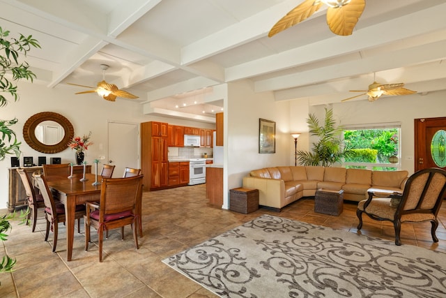 tiled dining space with ceiling fan and beamed ceiling