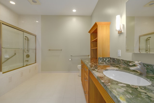 full bathroom with combined bath / shower with glass door, vanity, and toilet