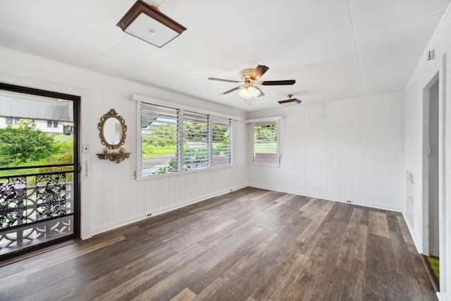 spare room with ceiling fan and dark wood-type flooring