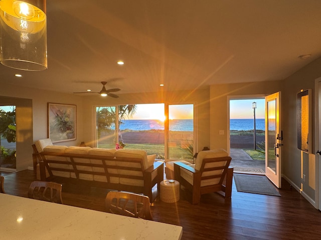 interior space with ceiling fan and a water view