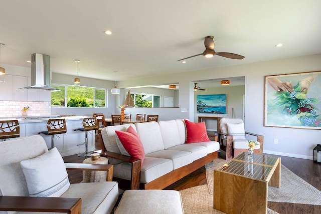 living room with hardwood / wood-style flooring and ceiling fan