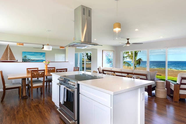 kitchen with ventilation hood, electric stove, decorative light fixtures, a water view, and white cabinetry