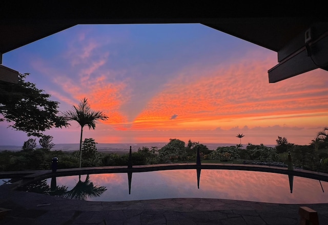 view of pool at dusk