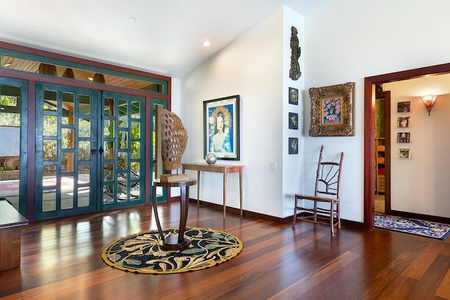 interior space with french doors, dark wood-type flooring, and lofted ceiling