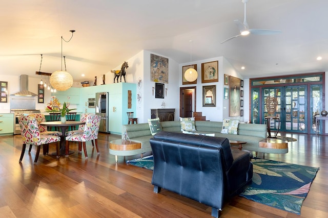 living room with hardwood / wood-style floors, ceiling fan, and lofted ceiling