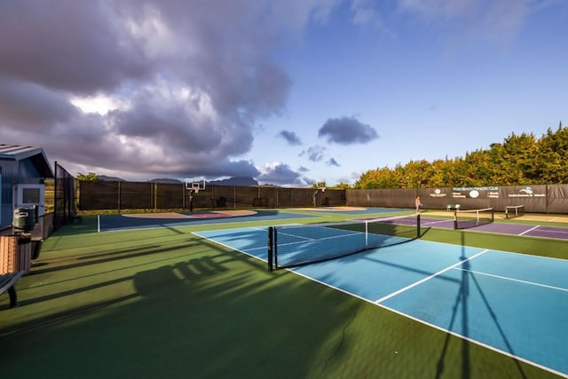 view of tennis court featuring basketball hoop