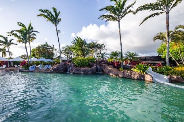 view of swimming pool with a water view and a water slide