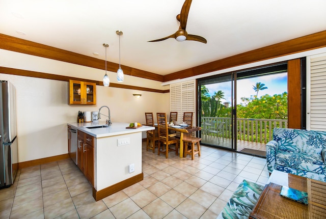 kitchen with ceiling fan, sink, hanging light fixtures, kitchen peninsula, and appliances with stainless steel finishes