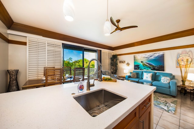 kitchen featuring ceiling fan, sink, light tile patterned flooring, and hanging light fixtures