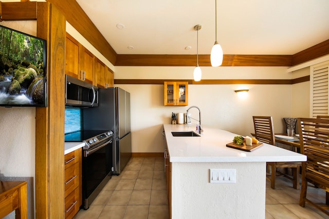 kitchen featuring tile patterned floors, decorative light fixtures, sink, and stainless steel appliances