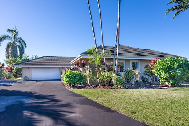 ranch-style home with a garage and a front yard