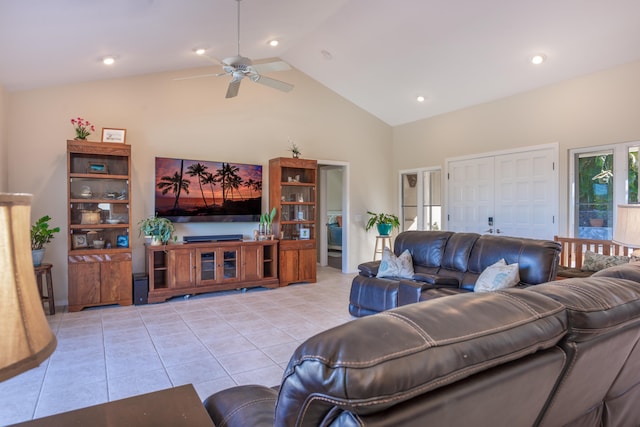 living room with ceiling fan, light tile patterned floors, and high vaulted ceiling