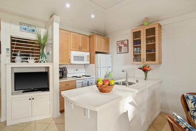 kitchen featuring kitchen peninsula, sink, light tile patterned floors, and white appliances