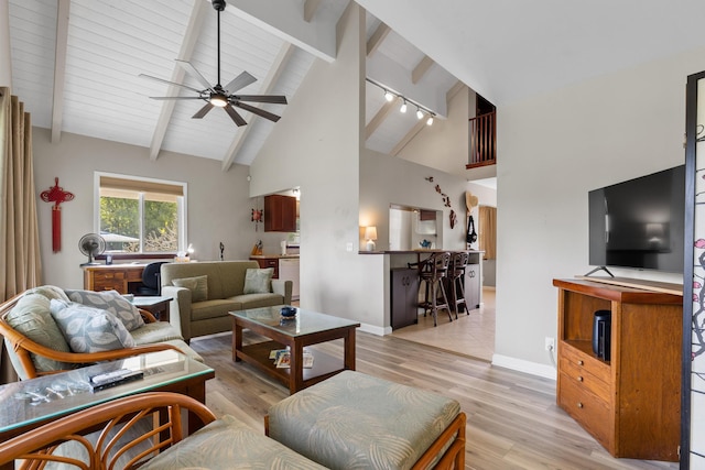 living room featuring high vaulted ceiling, light hardwood / wood-style floors, beamed ceiling, and ceiling fan