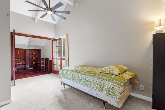 bedroom with lofted ceiling with skylight, carpet flooring, and ceiling fan