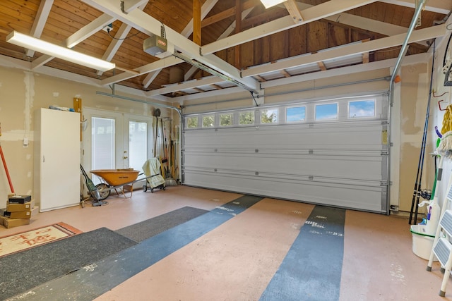 garage featuring a garage door opener, wood ceiling, and french doors