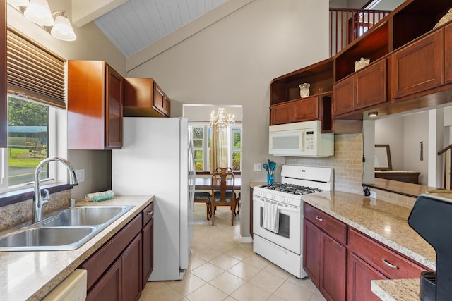 kitchen with lofted ceiling with beams, white appliances, sink, and a healthy amount of sunlight