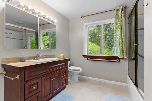 full bathroom with toilet, tile patterned floors, vanity, and shower / bath combination with glass door