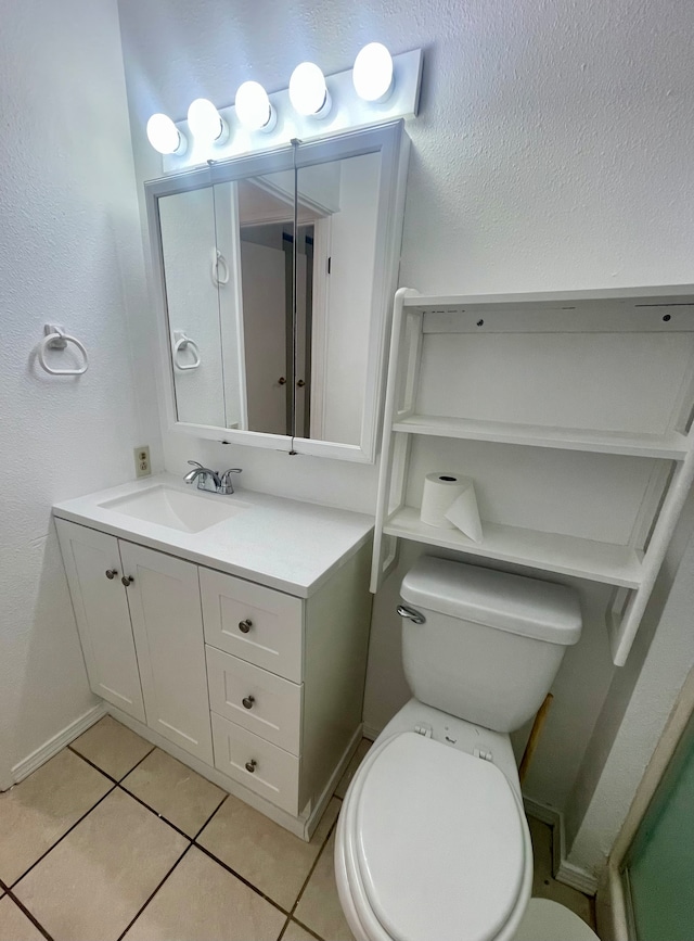 bathroom with tile patterned flooring, vanity, and toilet