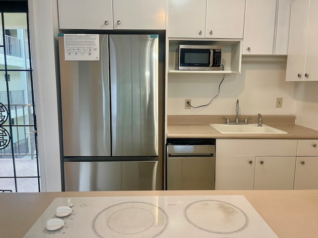 kitchen with white cabinetry, sink, and stainless steel appliances