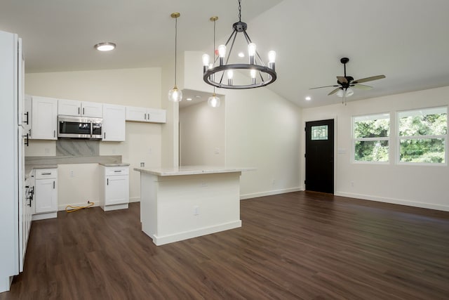 kitchen featuring white cabinetry, dark hardwood / wood-style flooring, a center island, and pendant lighting