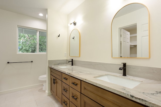 bathroom featuring toilet, vanity, and tile patterned floors