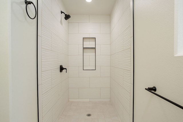 bathroom with tiled shower