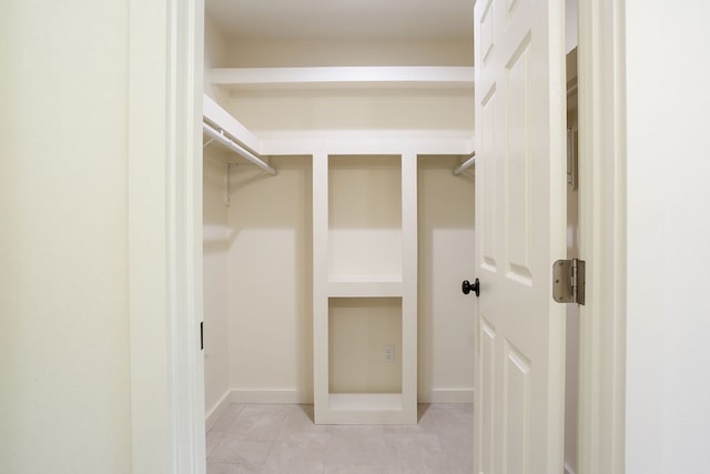 spacious closet with light tile patterned flooring