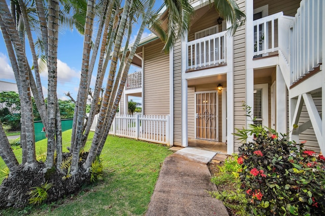 entrance to property with a lawn