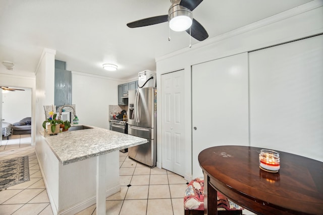 kitchen with sink, kitchen peninsula, stainless steel fridge, crown molding, and light tile patterned flooring