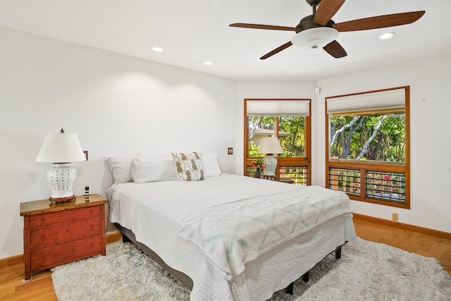 bedroom with ceiling fan and light wood-type flooring