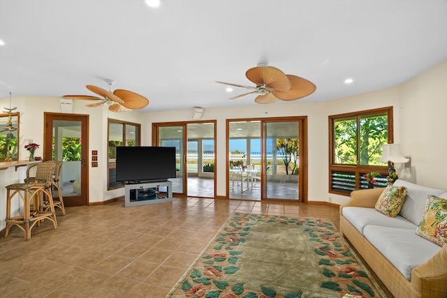 living room featuring ceiling fan and light tile patterned flooring