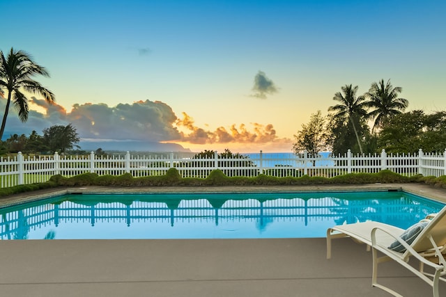 view of pool at dusk