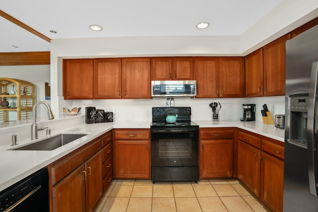 kitchen with black appliances, sink, and light tile patterned flooring