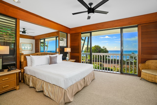 bedroom with access to outside, ceiling fan, a water view, and light colored carpet