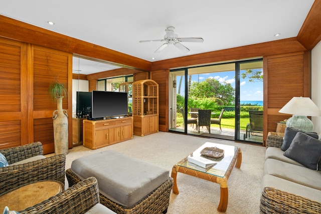 carpeted living room with ceiling fan