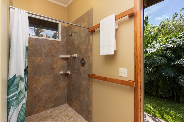 bathroom featuring ornamental molding and curtained shower