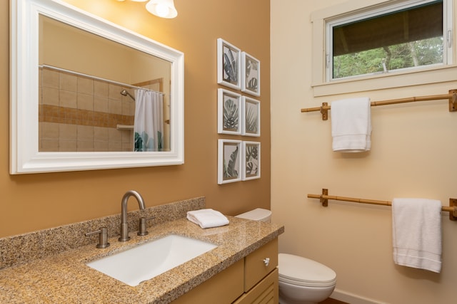 bathroom with walk in shower, vanity, and toilet