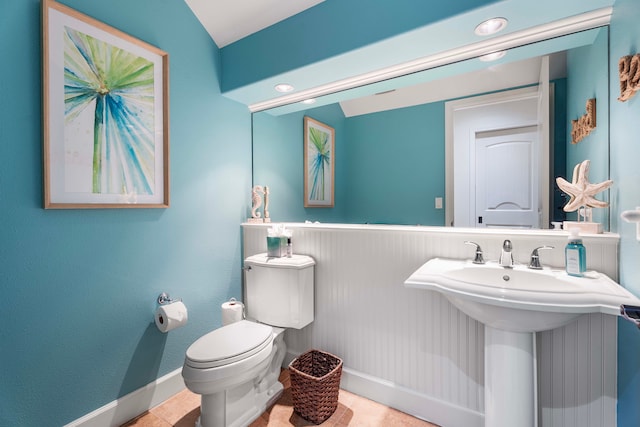 bathroom with tile patterned flooring, toilet, and sink