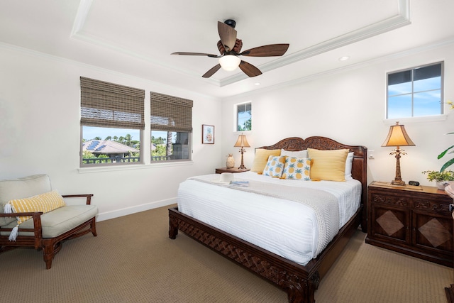 bedroom featuring carpet flooring, ceiling fan, crown molding, and a tray ceiling