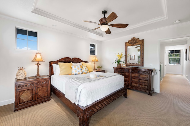 bedroom featuring a tray ceiling, ceiling fan, and light colored carpet