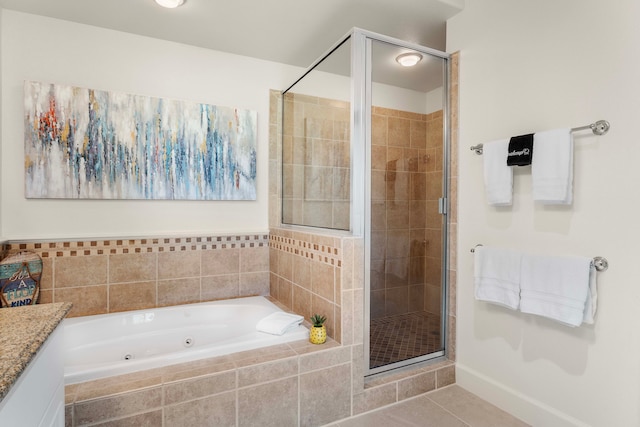 bathroom featuring tile patterned flooring, vanity, and separate shower and tub